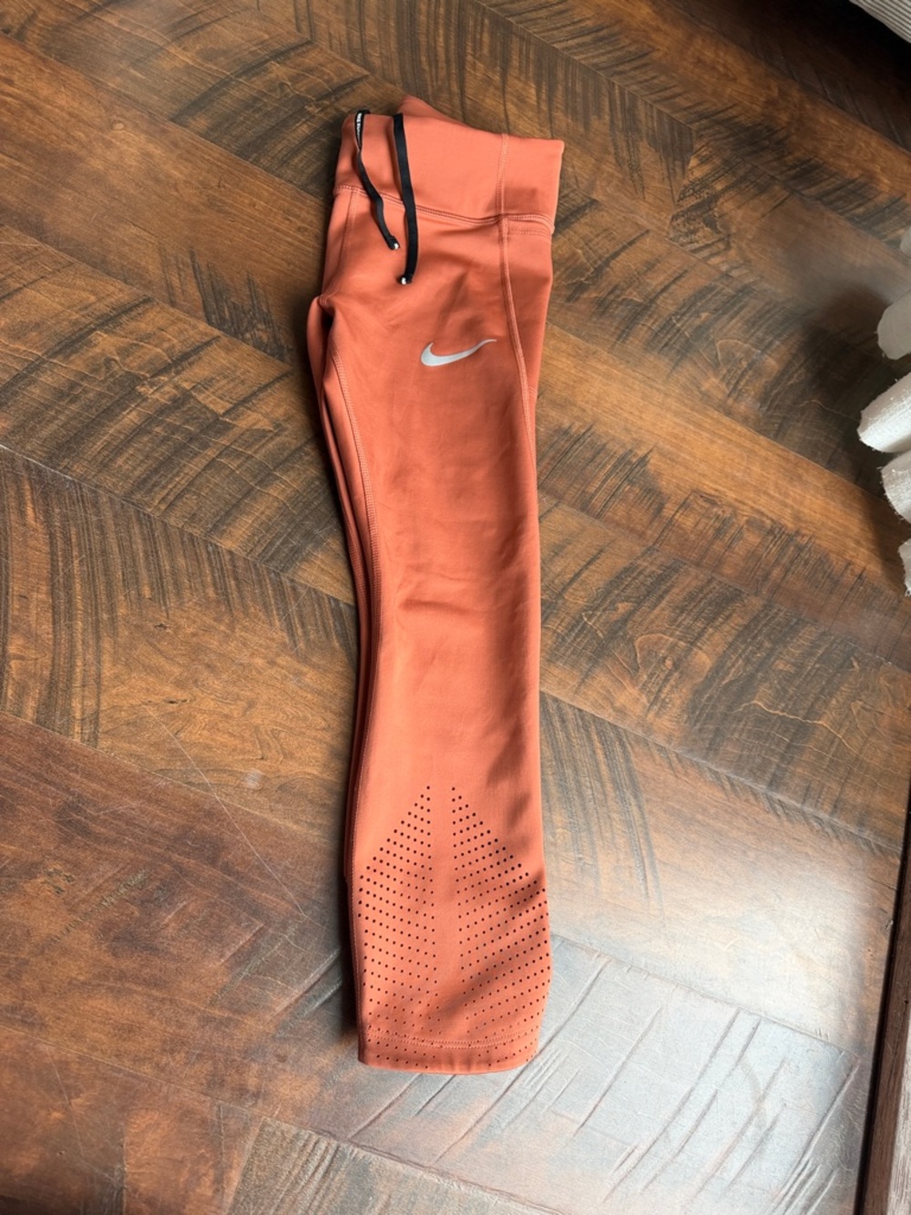 Nike Rust Orange woman’s ' Performance Leggings with Perforated Cuffs